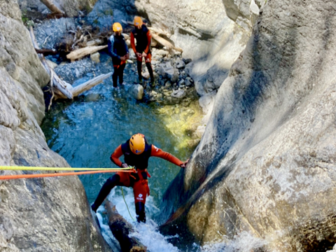 Rappelling down a canyon waterfall into one of the standing pools close to Banff and Canmore