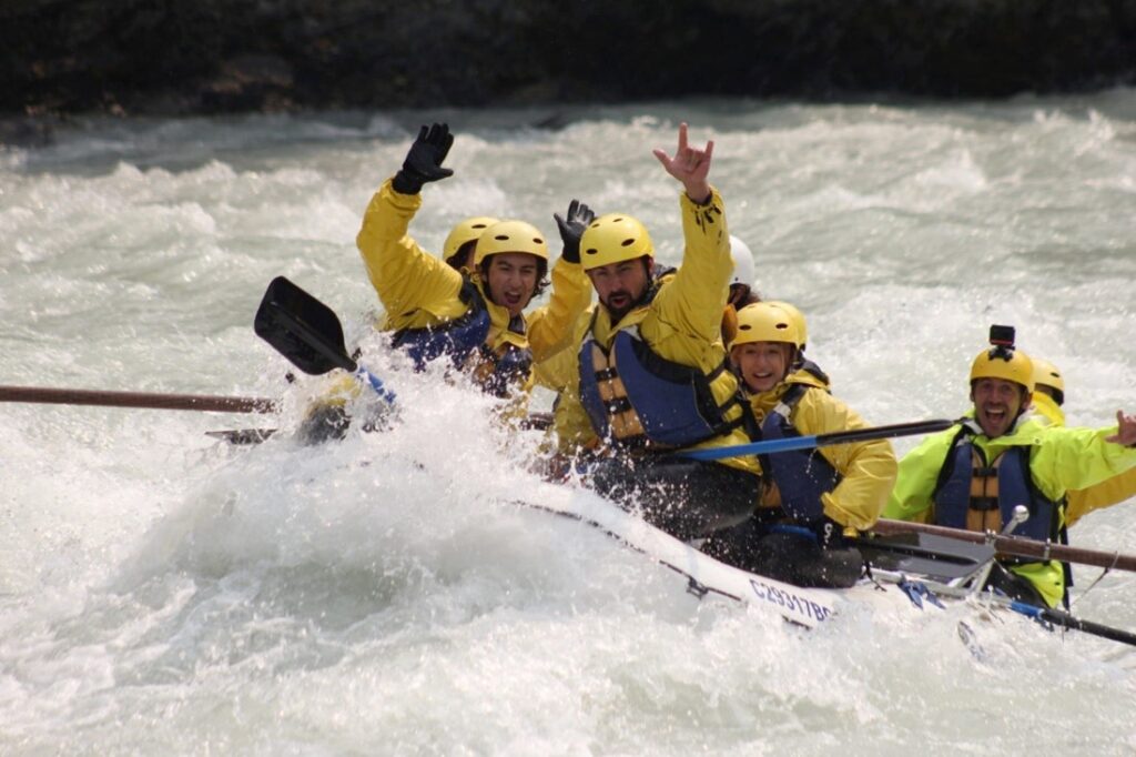 Rafters hitting a big wave on the Kicking Horse River while rafting with Wild Water Adventures