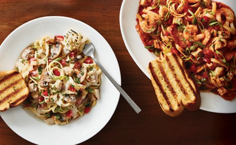 Featured pasta dishes with a side of garlic toast served at Boston Pizza in Canmore, Alberta for the Tuesday pasta night special