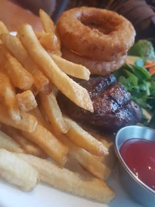 Steak Sandwich with fries, onion rings and salad at Sandtraps in Canmore, Alberta, their Tuesday dining special