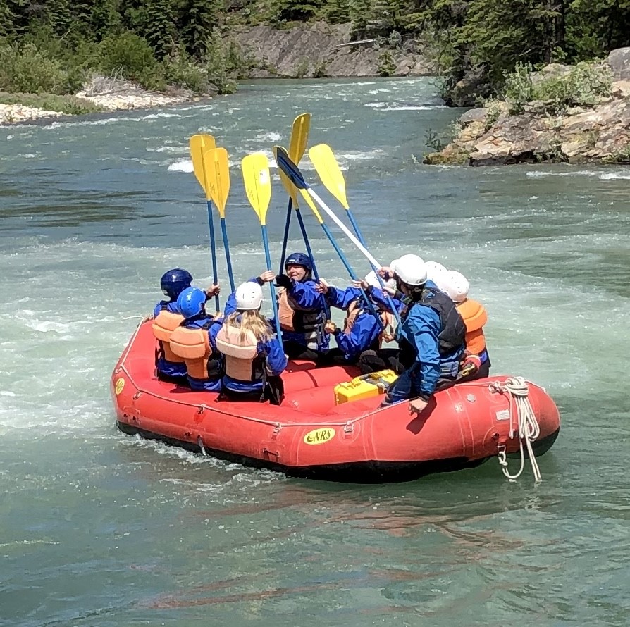 Group of rafters doing a paddle high five
