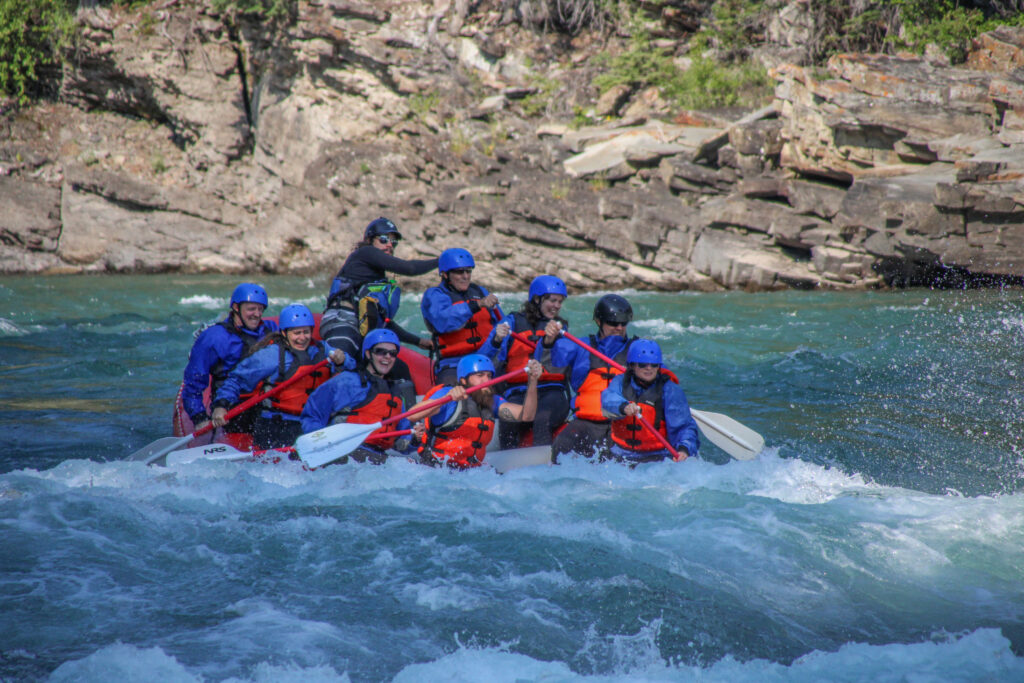 Rafters paddling through whitewater