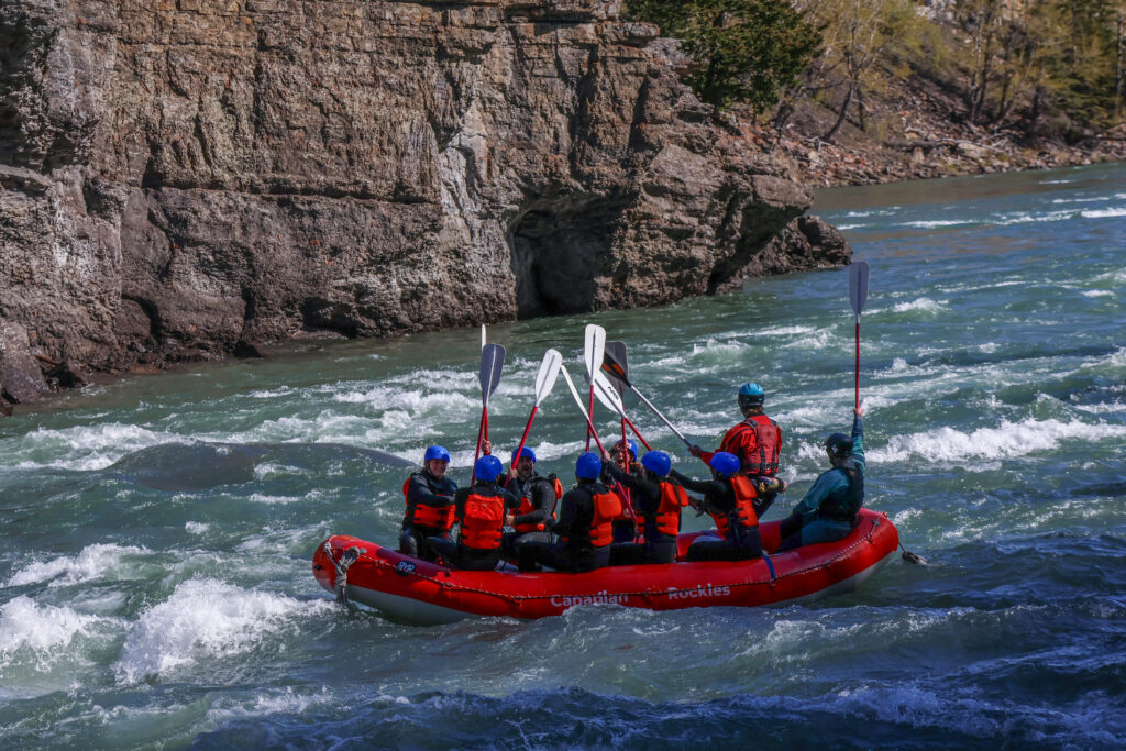 Paddle high five to celebrate - team bonding on the Horseshoe Canyon with Canadian Rockies Rafting